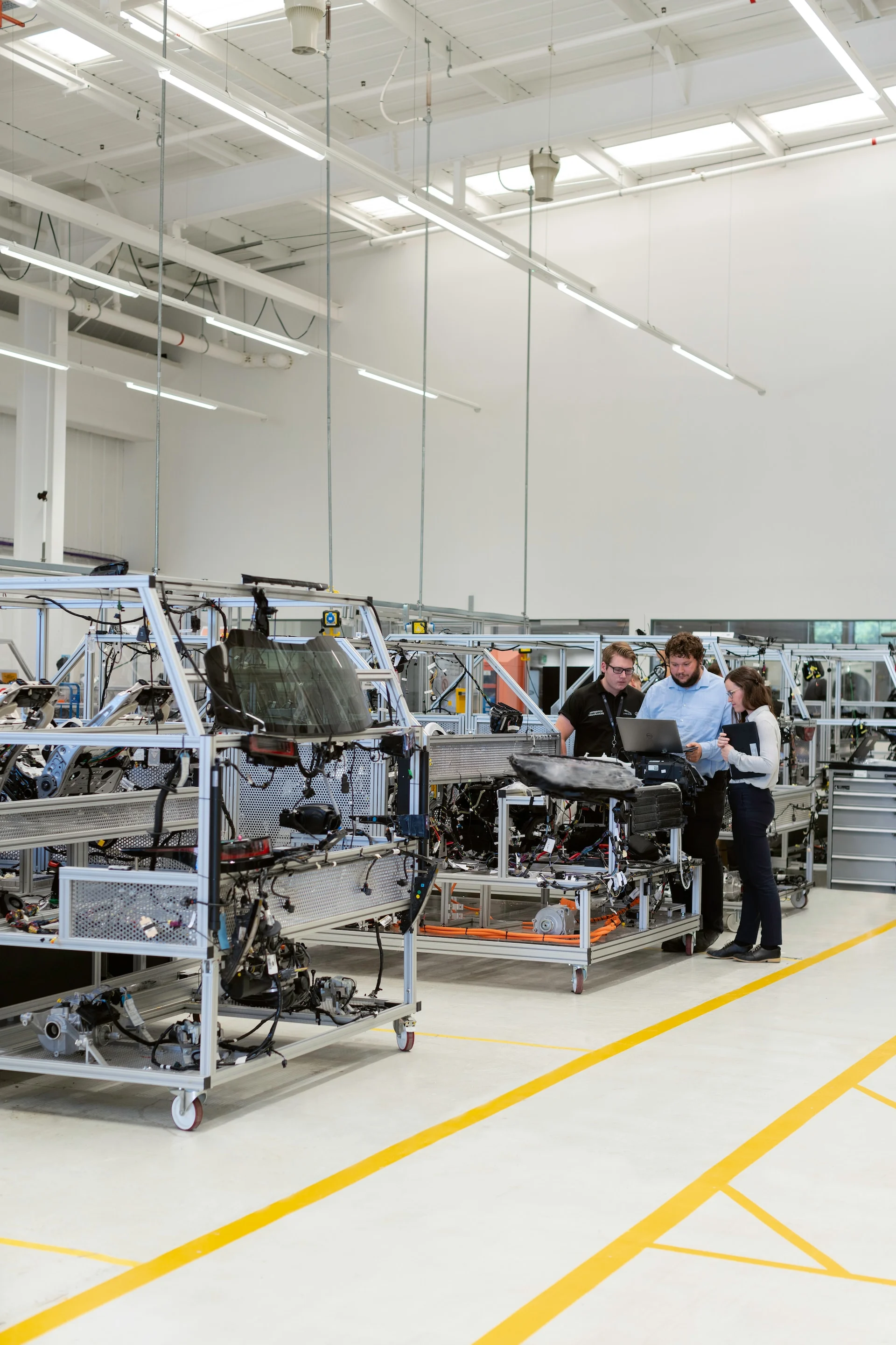 Group of engineers standing around a computer in the Fusion office