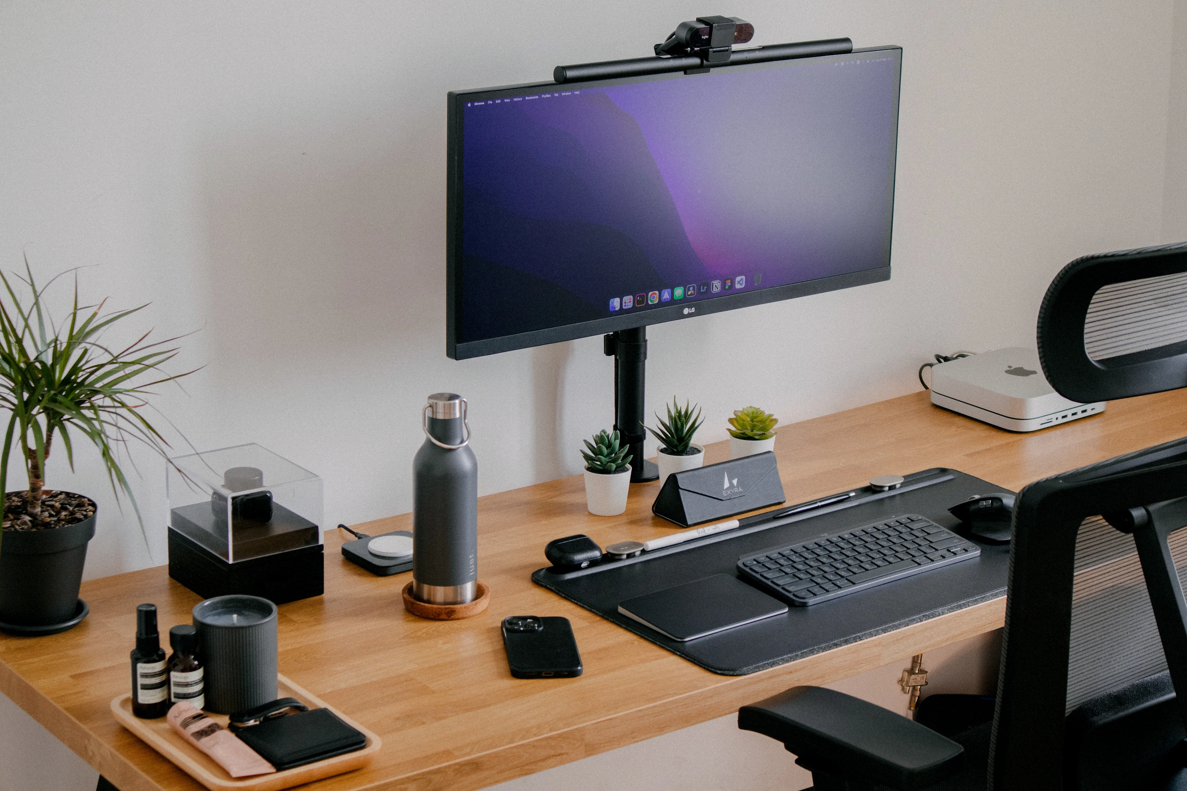 Office desk with a monitor, keyboard, and other electronics