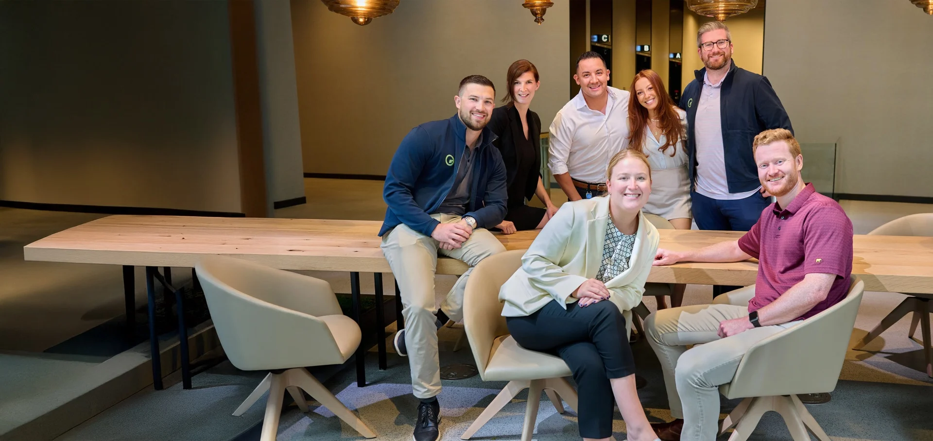 The Fusion Worldwide team gathered around a table in a warmly lit office.
