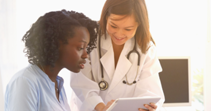 A doctor pointing to a tablet device discussing responsible pain relief options with a patient.