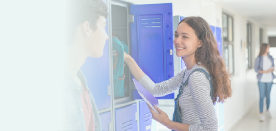 A teenager reaching into her school locker.