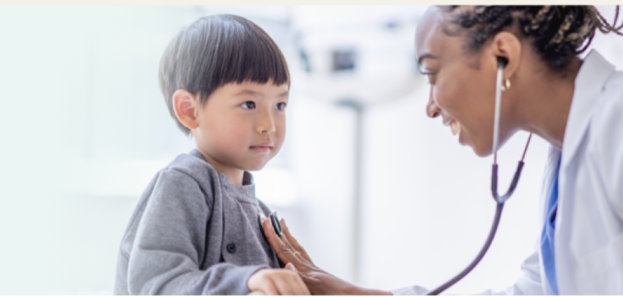 A pediatrician listening to her patient’s heart with a stethoscope.