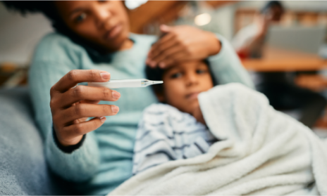 A mother measuring her child’s temperature. 