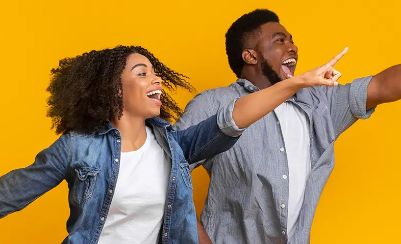 Two people pointing upwards