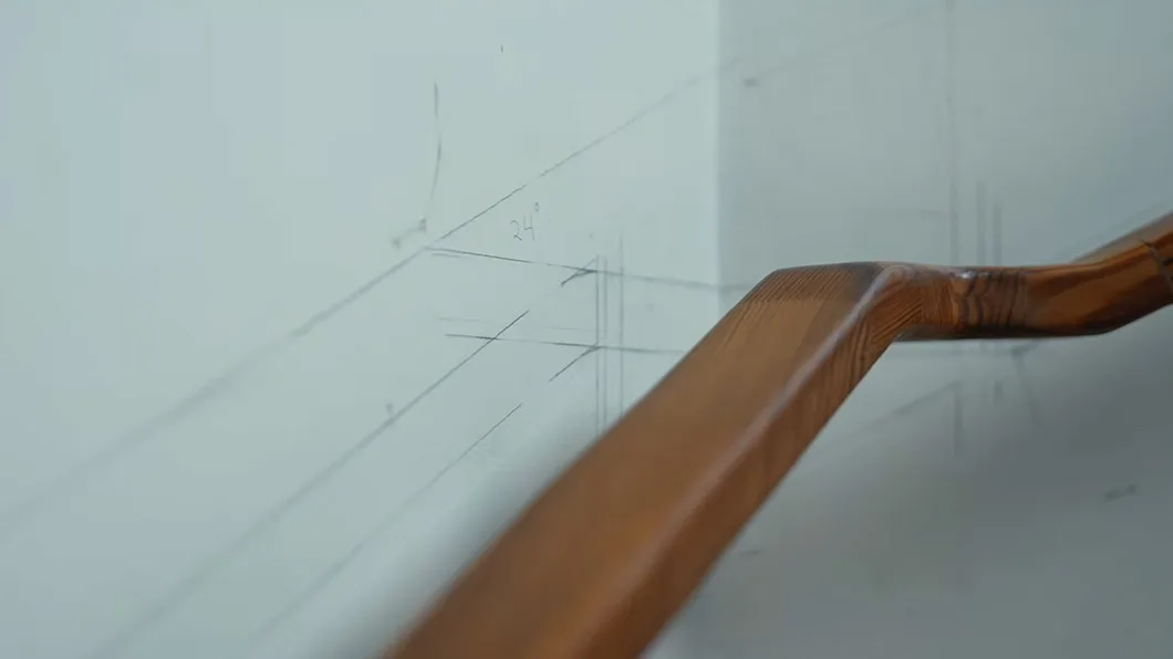 Image of a stair bannister, with pencil calculation drawings written on the white paint behind.