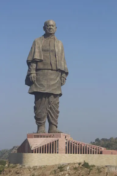 The Statue of Unity, a monumental statue of Indian statesman and independence activist Sardar Vallabhbhai Patel, stands tall against a clear blue sky.
