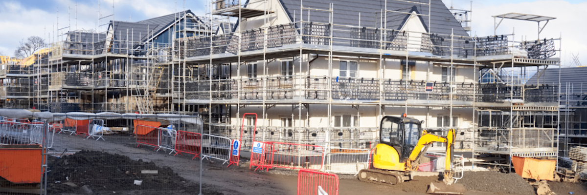 Housing development site with scaffolding and construction equipment