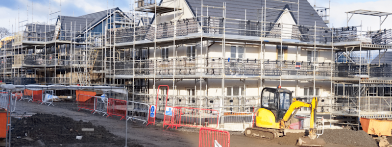 Housing development site with scaffolding and construction equipment