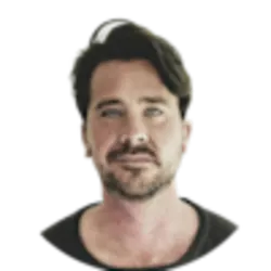 Headshot of a man with dark, wavy hair and a beard.