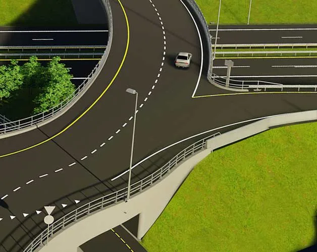 A car drives on a multi-level highway interchange with green grass surrounding the roads.