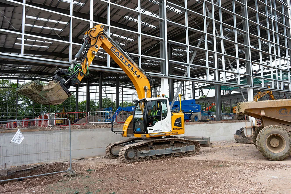 Trimble Earthworks Excavator Near Building
