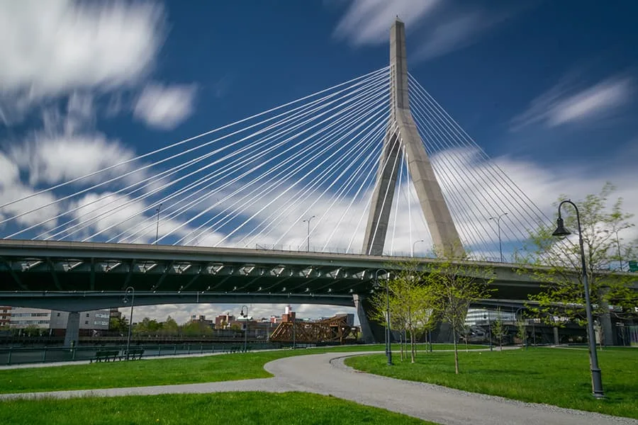 Zakim Bridge, Boston, MA. A cable-stayed bridge against a blue, cloudy sky.