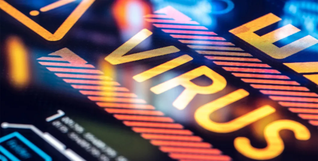 Close-up of a digital screen displaying the word "VIRUS" in bold, bright letters, with warning symbols and tech graphics.
