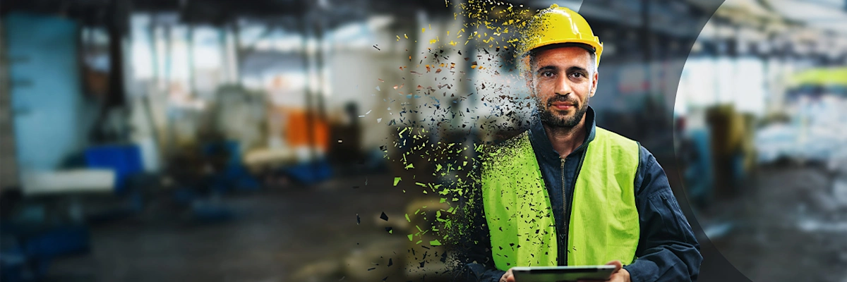 A worker in a yellow hard hat and safety vest dissolves into digital fragments against a blurred industrial background, symbolizing digital transition.