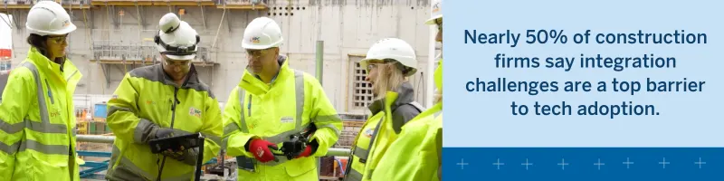 Construction workers discuss technology adoption challenges on a job site.