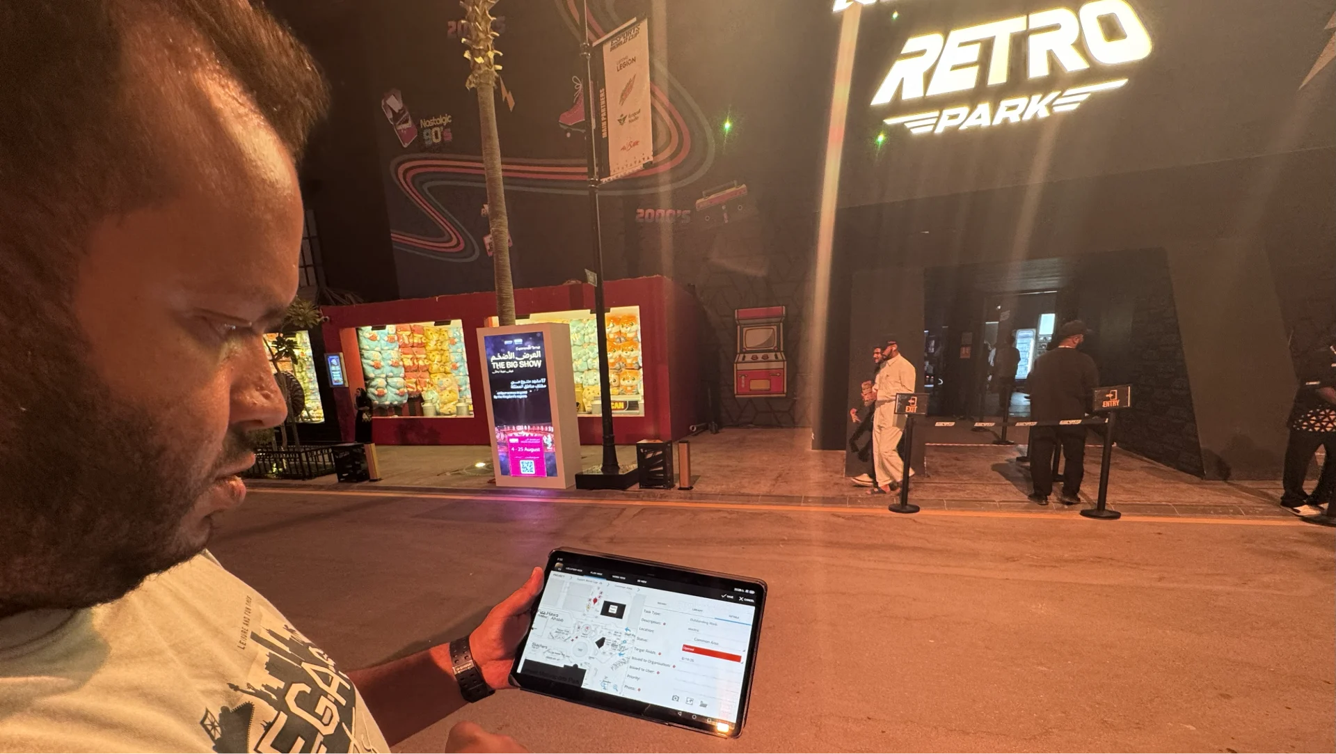 A man using Viewpoint Field View on a tablet, with "Retro Park" visible in the background at the Esports World Cup