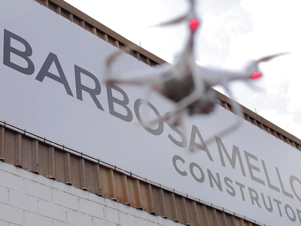 Drone flying over the BARBOSA MELLO CONSTRUTOR sign.