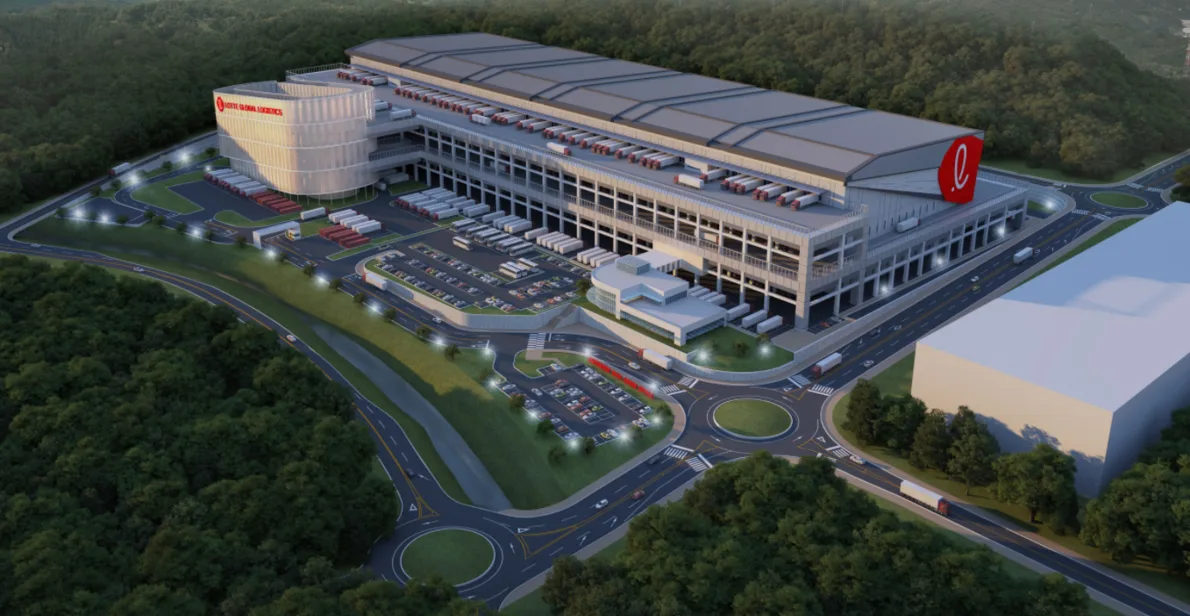 A 3D rendering of the Mega Hub, a large warehouse facility with a curved glass administrative building and a long, multi-story warehouse structure.