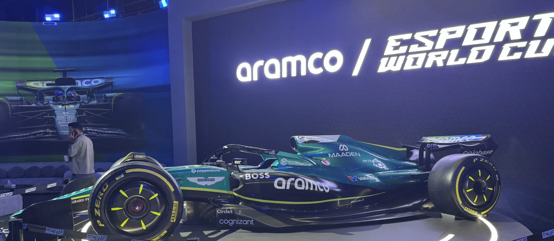 A sleek, greenF1 car is displayed at the Esports World Cup