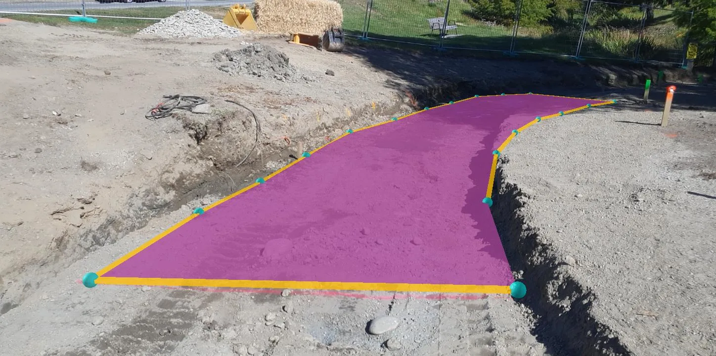 Construction site with a purple-highlighted path outlined in yellow and marked by green and yellow posts.