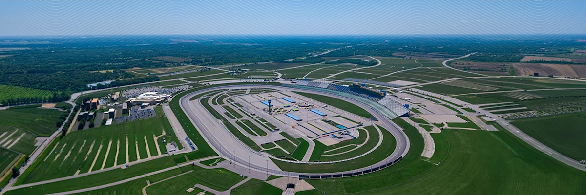 An aerial view of the tri-oval Kentucky Speedway in Sparta, Kentucky, with Trimble’s corporate blue wave branding across the top of the image.