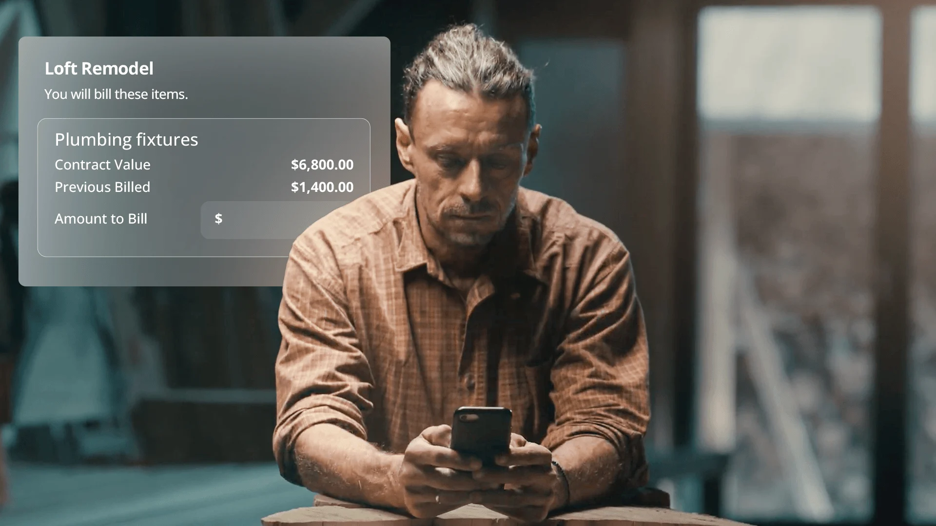 A contractor looks closely at his smartphone with a "Loft Remodel" digital billing menu overhead.