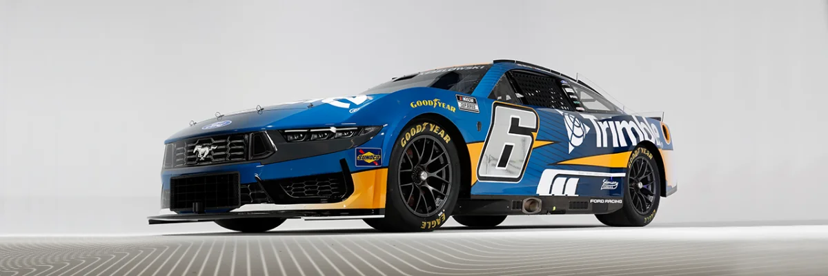 A blue and yellow #6 Ford Mustang NASCAR Cup Series car driven by Brad Keselowski, featuring primary Trimble branding and sponsorship.