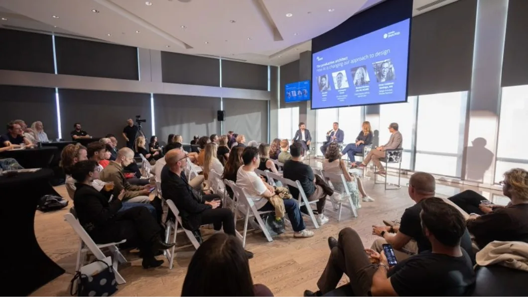 Audience watching panel of experts talking about AI and design at AIA event.