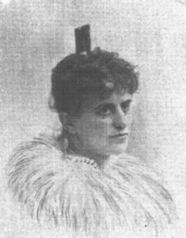 Portrait of a woman with a feathered boa and a small ornament on her updo hairstyle.