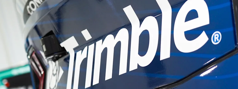 Trimble logo on a blue vehicle featuring a side-mounted camera sensor, with a CONEXPO-CON/AGG trade show decal visible in the background.