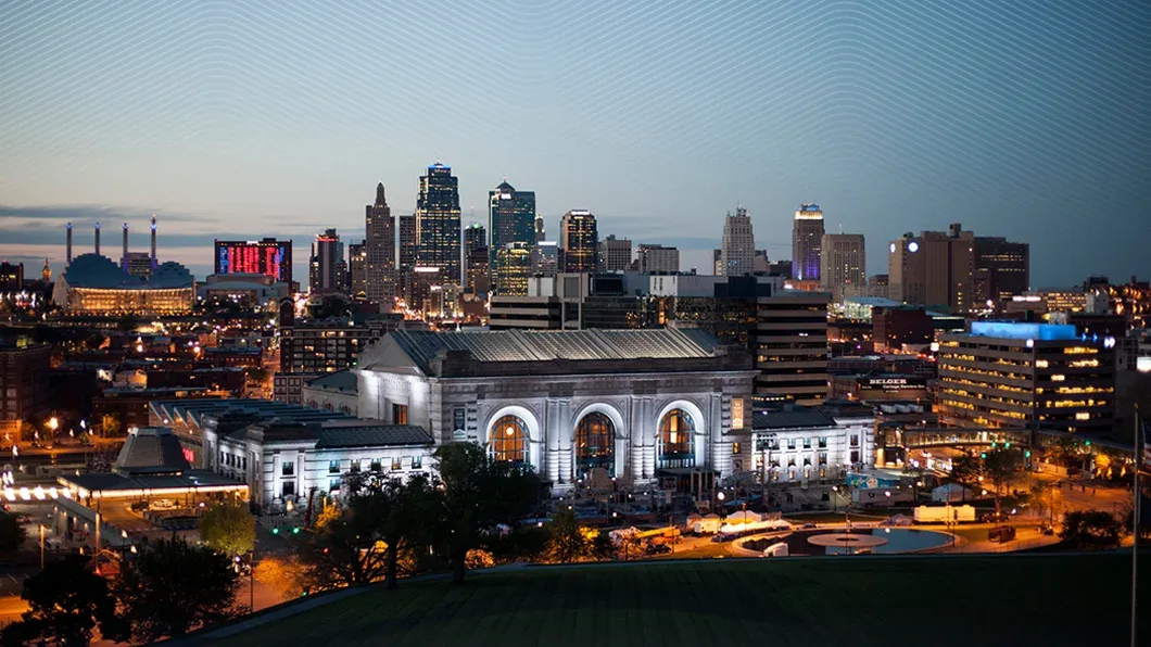 A twilight view of the Kansas City skyline with Union Station, featuring a white line overlay representing Trimble's connected construction technology