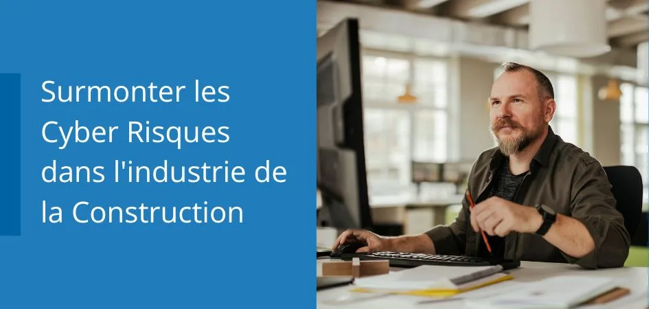 A man sitting at a desk in an office, looking at a computer screen. The text says Surmonter les Cyber Risques dans l'industrie de la Construction.