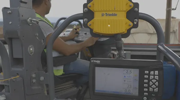 machine operator uses Trimble machine control in paving cab