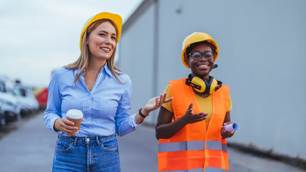 Exploring diverse career paths in construction - Image of two women in hard hats talking