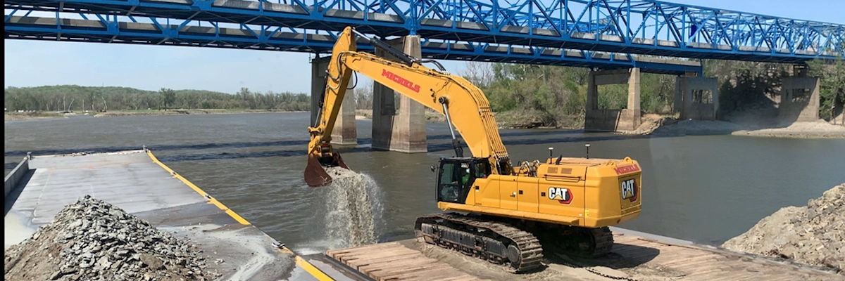 An excavator equipped with TMC removes bedrock from the Missouri River
