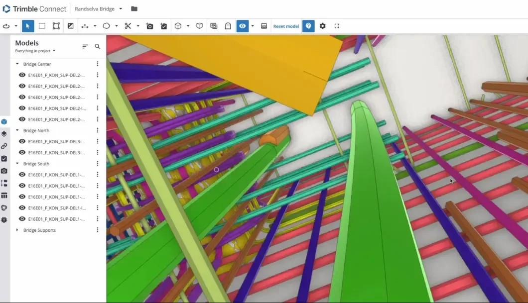 A 3D model of a bridge is displayed on a computer screen, showing a complex network of colorful structural elements.