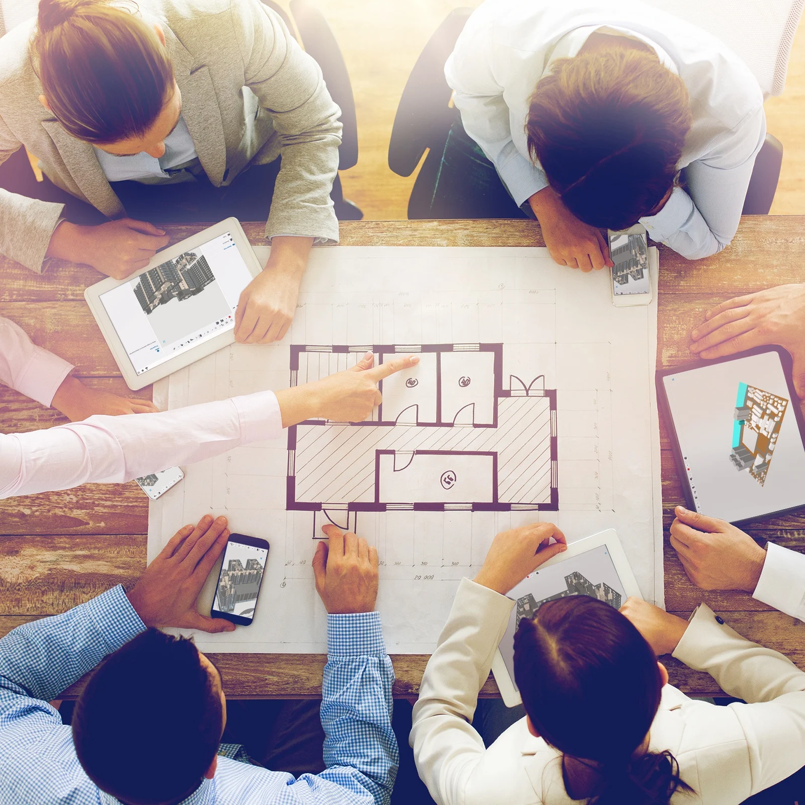 Team of architects collaborating over blueprints and digital designs at a conference table.