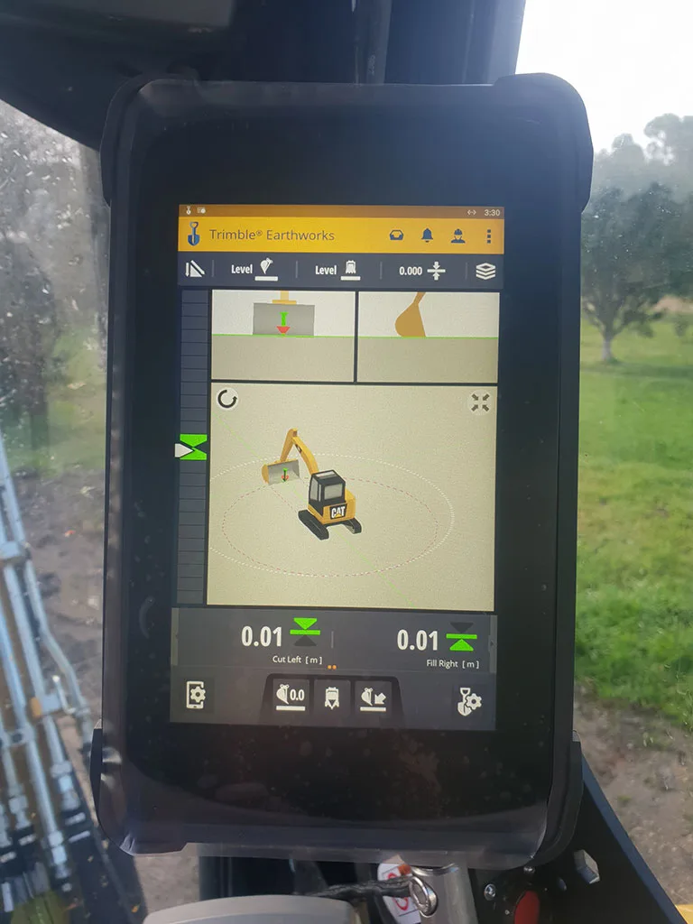 Trimble Earthworks display shows an excavator model and cut/fill measurements.