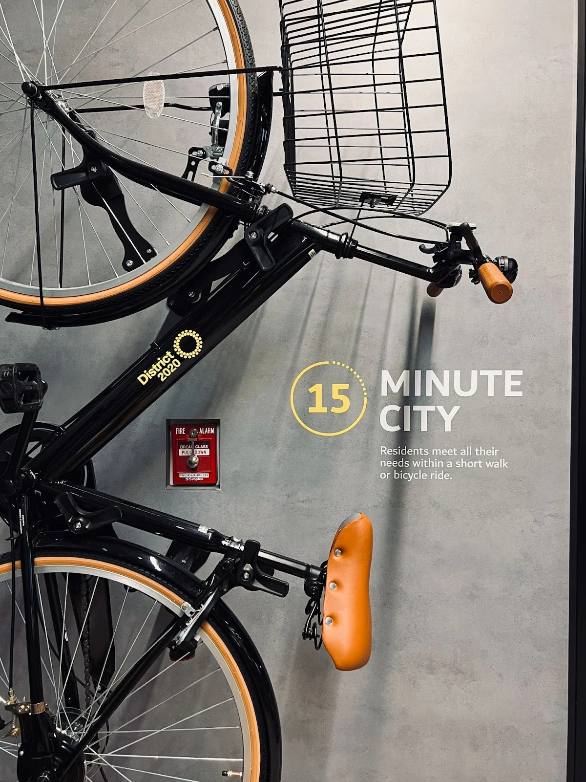 A bicycle with a basket is displayed, promoting the concept of a 15 Minute City.