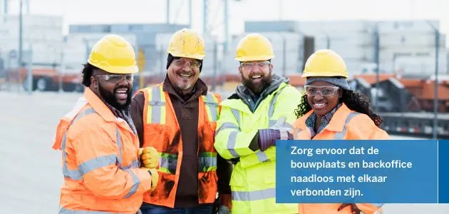 Four construction workers in hard hats and safety vests smile at the camera.
