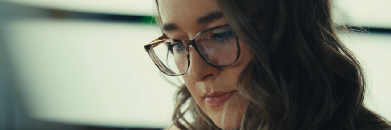 Kailey looks down at papers in her workspace.
