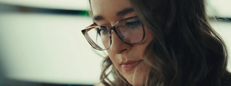 Kailey looks down at papers in her workspace.