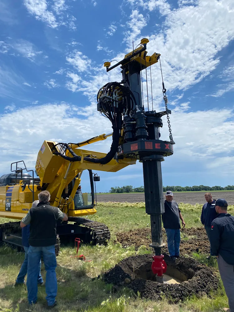 Crew using a drilling rig for geothermal installation.