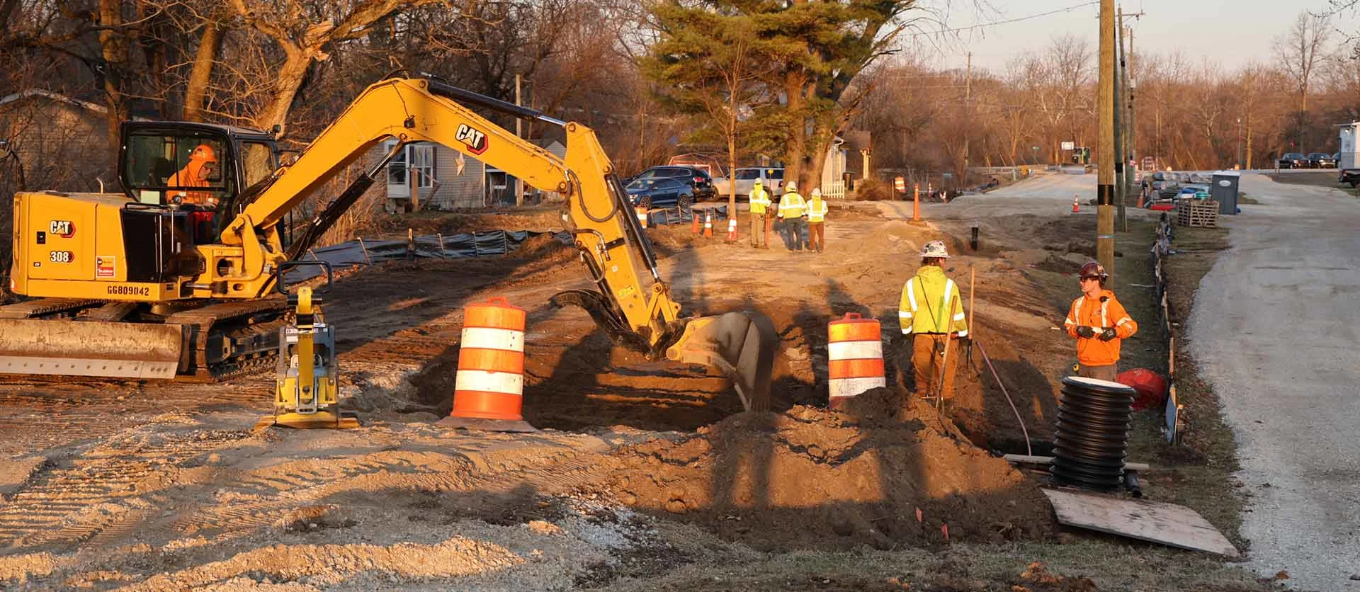 Bowen crew works on a service lateral from a newly installed main line in a residential area.