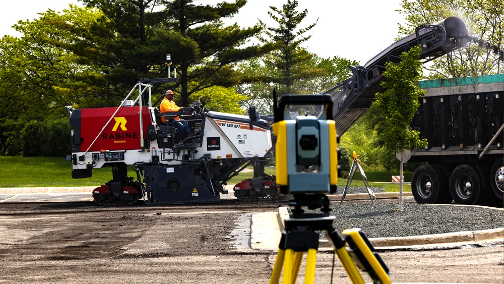 Total station with milling machine in the background