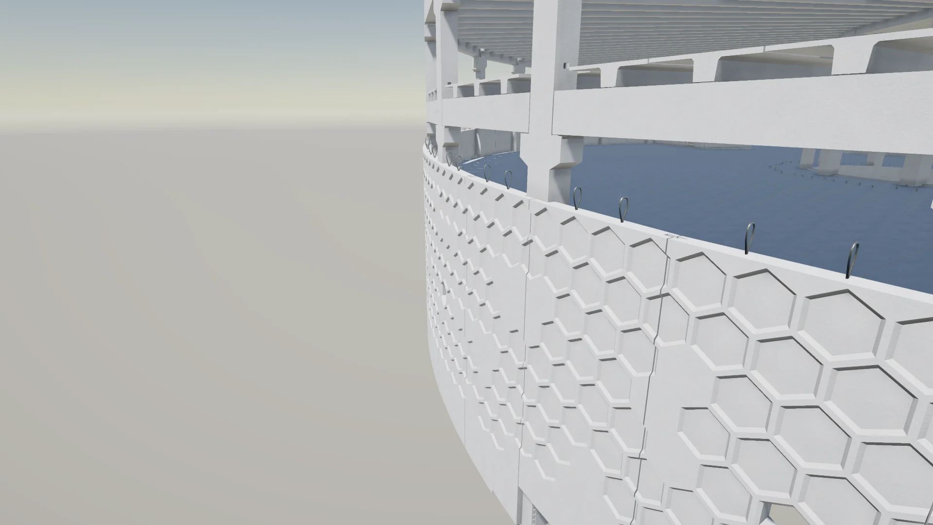 A close-up of a white, honeycomb-patterned facade on a curved building.