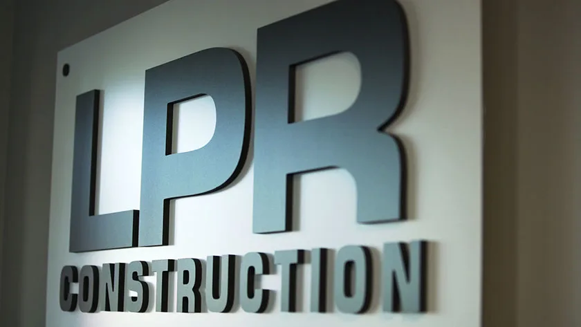 LPR Construction sign with raised dimensional letters on a white background.