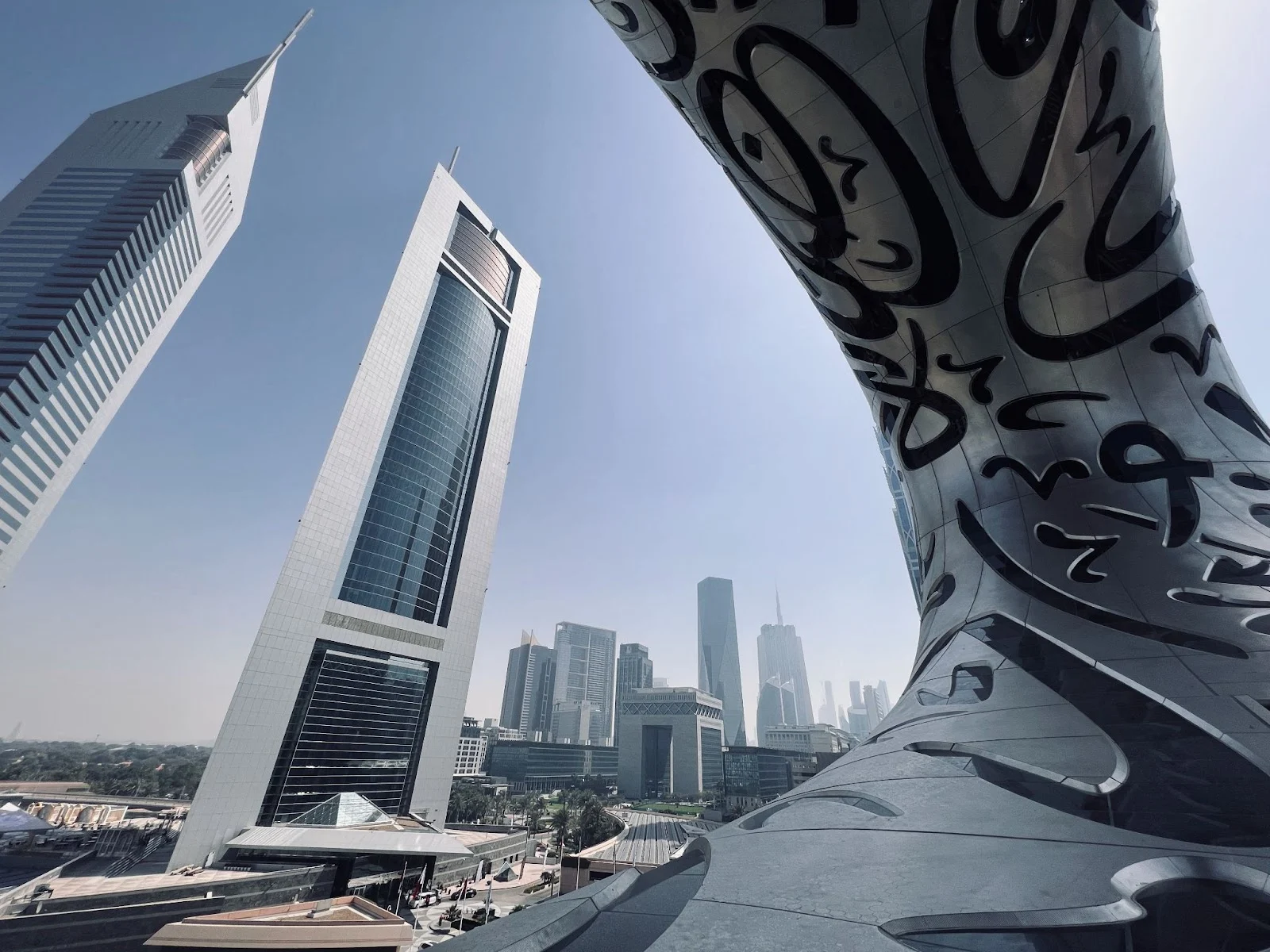Futuristic Dubai Museum of the Future with skyscrapers in the background under a clear blue sky.