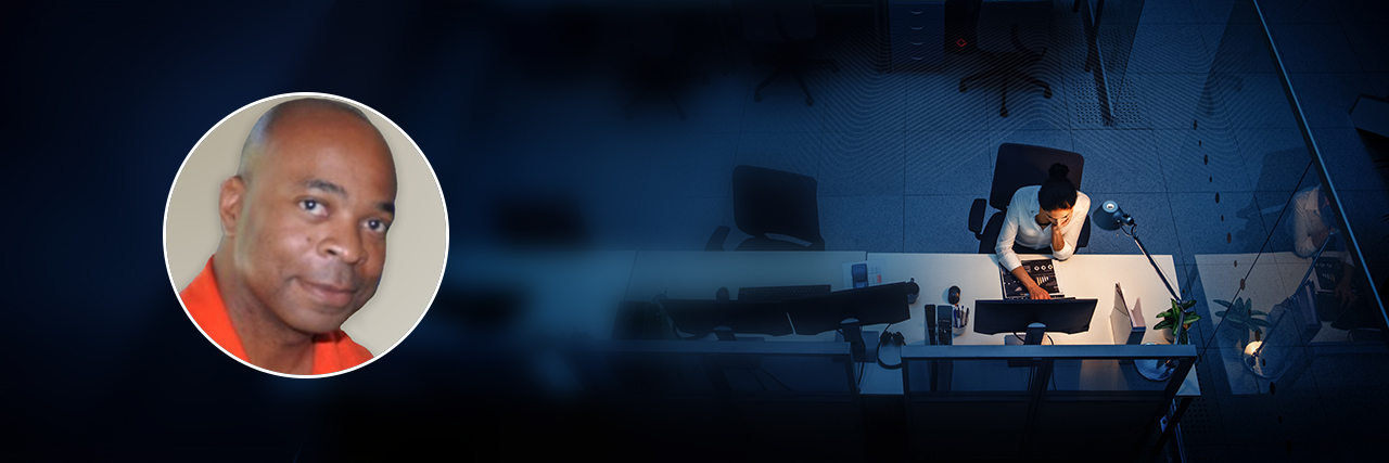 Portrait of Kevin Eison of Microsoft overlaid onto overhead image of a woman using a laptop at a desk.