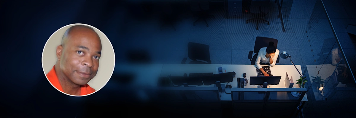 Portrait of Kevin Eison of Microsoft overlaid onto overhead image of a woman using a laptop at a desk.
